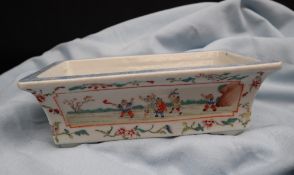 A Chinese porcelain planter of rectangular form with vignettes depicting children playing and