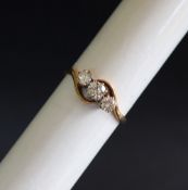A three stone diamond ring set with a central round brilliant cut diamond approximately 0.