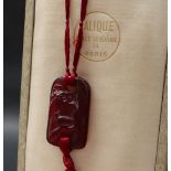 A Rene Lalique ruby glass pendant in the Colombes or Doves pattern,