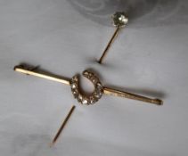 A 9ct yellow gold bar brooch with cushion cut diamond set horseshoe,