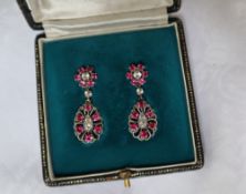 A pair of red spinel and white stone drop earrings, to a white metal setting and clip on back,