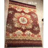 A large Aubusson type carpet with a central medallion with a rose roundel with floral and leaf