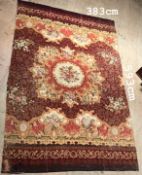 A large Aubusson type carpet with a central medallion with a rose roundel with floral and leaf