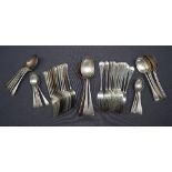 A George V silver part flatware service comprising a set of twelve table spoons,