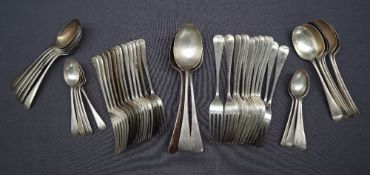 A George V silver part flatware service comprising a set of twelve table spoons,