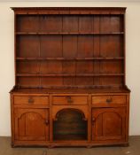 A 19th century oak dresser with a moulded cornice above three shelves,