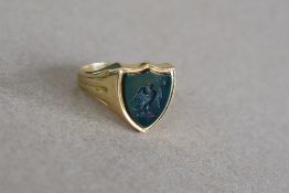 A yellow metal signet ring, with bloodstone shield with intaglio of an eagle, size P,