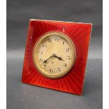 An Art Deco silver and red enamel desk clock of square form,
