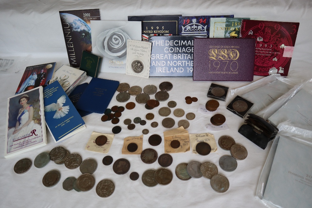 A collection of coins including Churchill crowns, Diana Princess of Wales memorial coin,