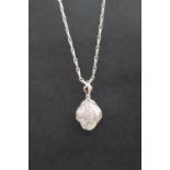 An 18ct white gold pendant set with baguette and round cut diamonds, on an 18ct white gold chain,