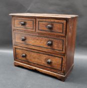 A miniature chest of drawers,