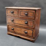 A miniature chest of drawers,