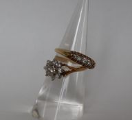 A diamond cluster ring set with a central raised old round cut diamond surrounded by eight old