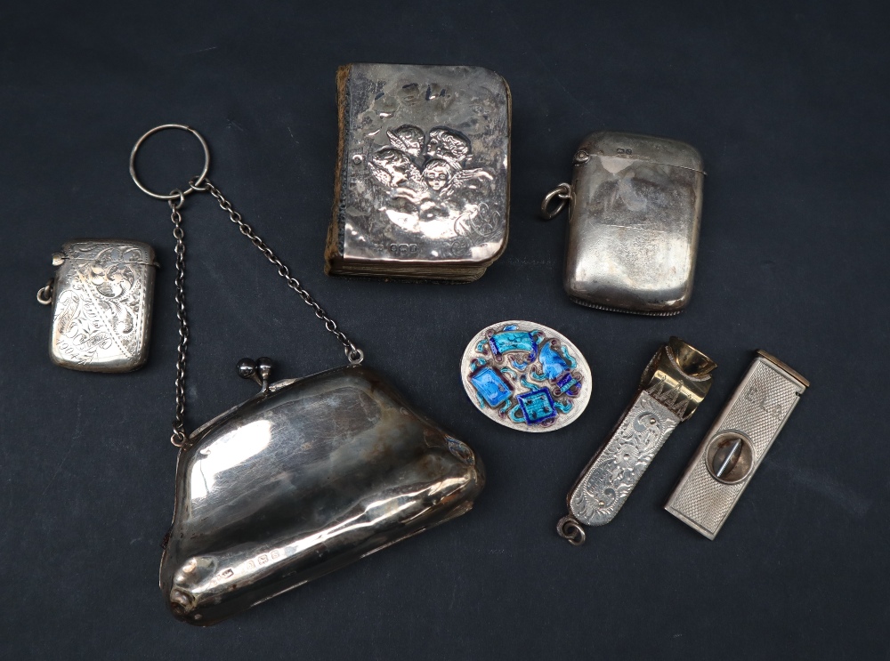 An Elizabeth II cigar cutter together with a Sterling Silver cigar cutter, silver purse,