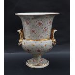 A 19th century porcelain vase campana vase of flared form with twin handles on a pedestal foot,