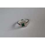 An emerald and diamond cluster ring,