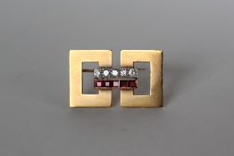A geometric ruby and diamond bar brooch of rectangular form set with five round old cut diamonds