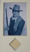 A Montage of a black and white photographs of John Wayne, signed to a separate sheet,