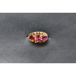 A 22ct gold ring set with three oval faceted amethysts set, size K 1/2 approximately 1.