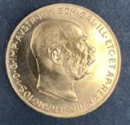 An Austrian 100 Corona Gold coin,