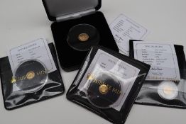 A 2021 Remembrance Day solid 22ct gold proof quarter sovereign together with three 24ct gold proof