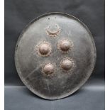A leather shield of circular domed form with an applied copper crescent and four copper domes,