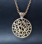 A 9ct gold pendant of circular form with geometric design, London, 1970, maker EJ Ld,