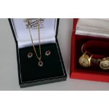 A 9ct gold ruby and diamond pendant on a 9ct gold chain, together with a pair of matching earrings,