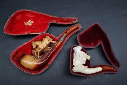A Meerschaum pipe carved in the form of a maiden in a floral carved bonnet,
