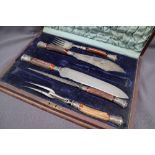 A Victorian silver mounted antler handled part carving set, comprising fish servers, carving knife,