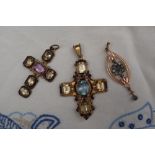 An yellow metal cross pendant set with a central rectangular faceted amethyst with citrines and