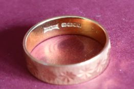 An 18ct yellow gold textured wedding band, size S,