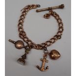 A 9ct yellow gold charm bracelet, with an anchor and heart, propelling pencil,