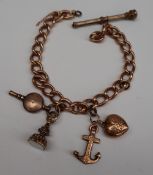 A 9ct yellow gold charm bracelet, with an anchor and heart, propelling pencil,