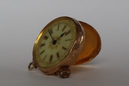 A yellow metal fob watch with a hinged loop, the circular dial with Roman numerals, marked 14k,
