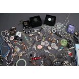 A large quantity of costume jewellery including brooches, pearl and semi precious stone necklaces,