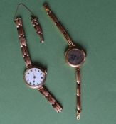 A 9ct gold wristwatch with an enamel dial and Roman numerals on a 9ct gold expanding bracelet strap,