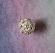 A diamond cluster ring, set with twenty five round old cut diamonds of circular floral form,