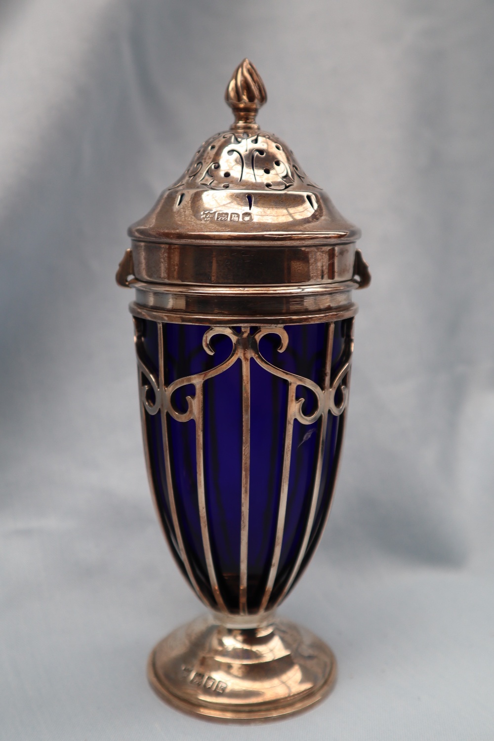 An Edward VII silver and blue glass sugar caster with a flame finial and pierced domed lid, - Image 2 of 4