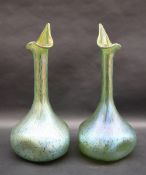 A pair of Loetz green glass single stem vases, with pointed opening and bulb base,