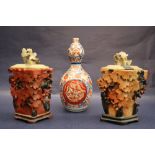 A pair of Chinese soapstone vases and covers decorated with fruiting vines,