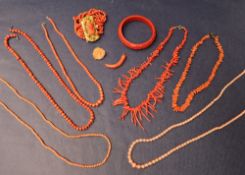A coral bead necklace together with other coral necklaces, beaded necklaces,