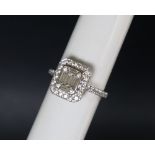 An 18ct white gold diamond cluster ring set with baguette and round brilliant cut diamonds to the