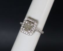 An 18ct white gold diamond cluster ring set with baguette and round brilliant cut diamonds to the