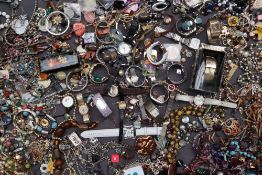 A large quantity of assorted costume jewellery including beaded necklaces, wristwatches, fans,