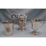 An early Victorian silver pedestal cup decorated with scrolling leaves and flowers with a
