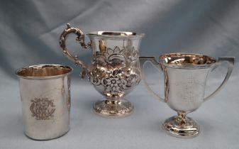 An early Victorian silver pedestal cup decorated with scrolling leaves and flowers with a