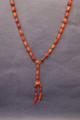 A long string of barrel shaped amber beads, smallest bead 13mm x 8mm, largest bead 30mm x 20mm,