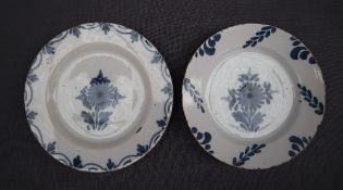 Two 18th century delft plates each painted with flowerheads and leaves, 17.5 and 18.