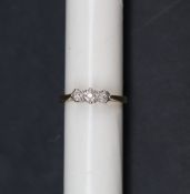 A three stone diamond ring, to a white metal setting and 18ct yellow gold shank, size L 1/2,